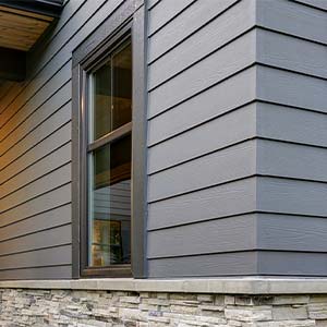 house with lap gray siding and white stone facade